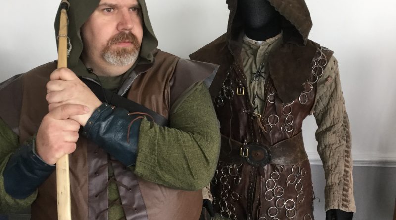 Cosplayer Mark Robinson next to authentic Robin costume